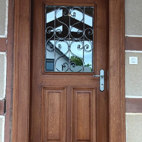 Porte extérieur bois massif avec panneaux et grille